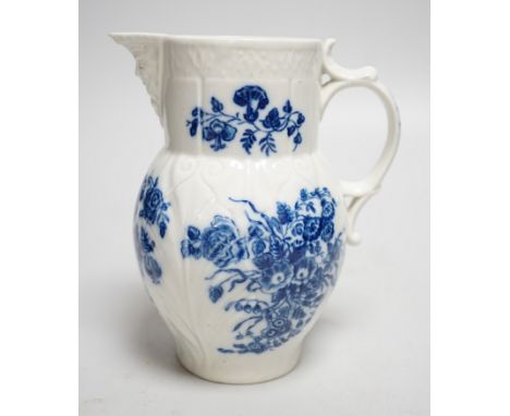 An 18th century Caughley mask jug printed with bouquets, C mark to base, 14.5cms high