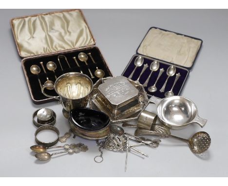 Assorted silver ware including two cased sets of six teaspoons, one with tongs, a christening mug, pierced sterling octagonal