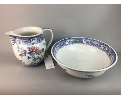 LOSOL WARE JUG AND WASH BASIN, decorated in blue, pink and yellow, the basin 41cm diameter