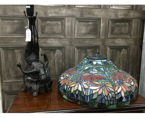 FIGURAL LAMP BASE, formed as a lady, modelled with her legs in the air, along with a Tiffany style glass shade, 46cm diameter