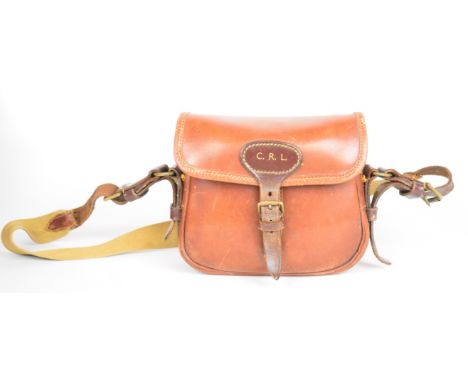 Leather 20 bore shotgun cartridge bag and belt, the bag with canvas shoulder strap and initials 'CRL'.&nbsp;