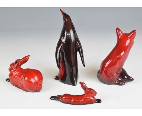 Four Royal Doulton flamb&eacute; animals comprising seated fox, two hares and a penguin, tallest 14.5cm