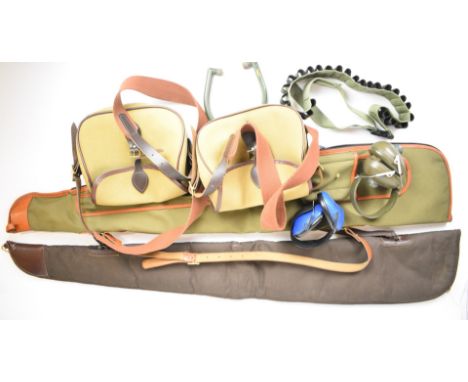 A collection of gun or shooting accessories comprising two gun slips, two shotgun cartridge bags, three pairs of ear defender