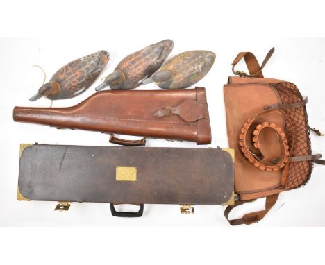 A collection of gun and shooting related items comprising two shotgun carry cases one a leather leg of mutton example, a canv