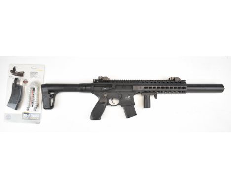 Sig Sauer MC .177 CO2&nbsp;assault style air rifle with textured pistol grip, multi-shot magazine, sound moderated barrel and