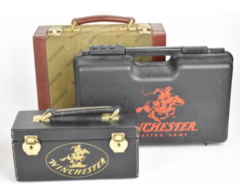 Three Winchester ammunition cartridges/ carry cases, one faux leather, one canvas and leather bound and one hard cased, large