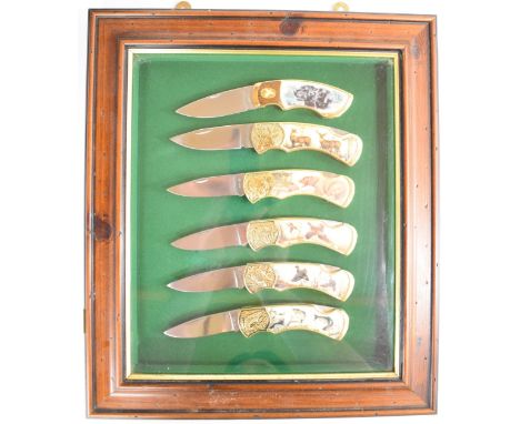 Framed set of six Franklin Mint hunting / shooting / fishing themed folding knives, L17cm, the display 38 x 33cm.&nbsp;PLEASE