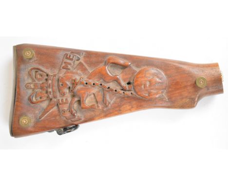 Trench art carved gun stock cribbage board with REME rearing horse motif, raised on shortened bullet legs, L28cm