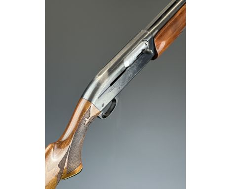 Remington Model 1100 12 bore 5-shot semi-automatic FAC shotgun with ornately carved and chequered semi-pistol grip and forend