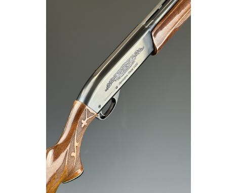 Remington Model 1100 LH 12 bore 3-shot semi-automatic shotgun with ornately carved and chequered semi-pistol grip and forend,