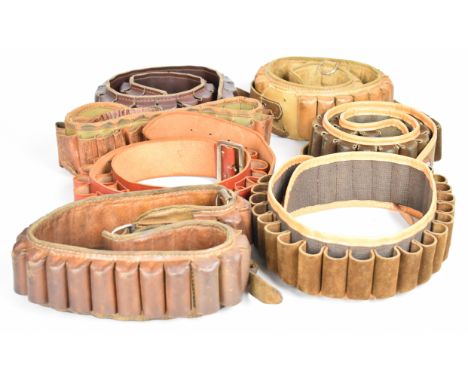 Seven leather and canvas shotgun cartridge belts.&nbsp;