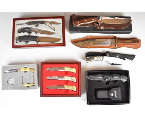 Seven Winchester and Walther knives and knife sets including one with laminated show wood handle, one with blade marked 'Winc