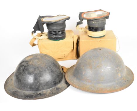 Two British WW2 Brodie steel helmets, both with liners and one with chin strap, together with two civilian respirators with b