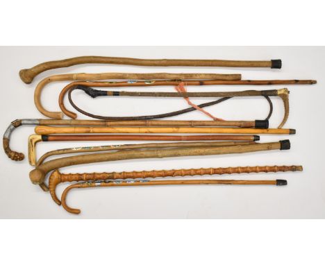 Ten various walking sticks and riding crops, one with silver mount opening to reveal a horse measuring stick and one with sta