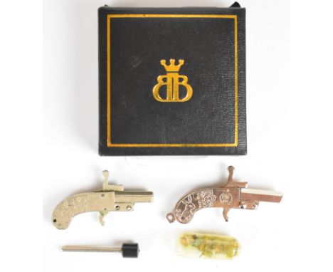 A near pair of Continental miniature pinfire hammer action pistols, each with engraved metal grips featuring deer and approxi