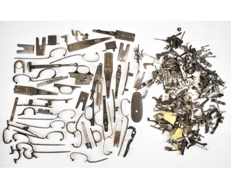 A collection of shotgun and rifle parts including triggers, top levers, extractors, locks, trigger guards, butt plates etc.&n