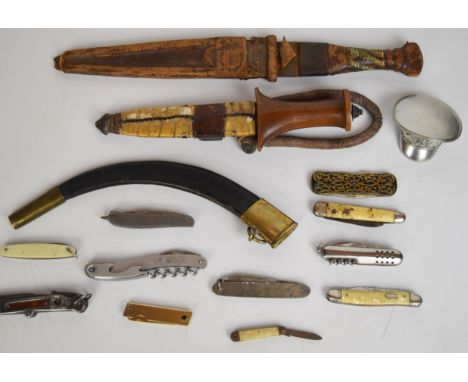 Two tribal daggers both with sheaths, longest blade 25cm, together with eleven pocket / folding knives.&nbsp;PLEASE NOTE: WE 