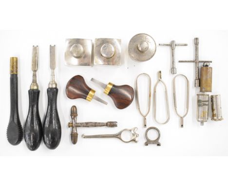 A collection of vintage gun tools and accessories including two James Purdey striker disc keys, three oil bottles, five cartr