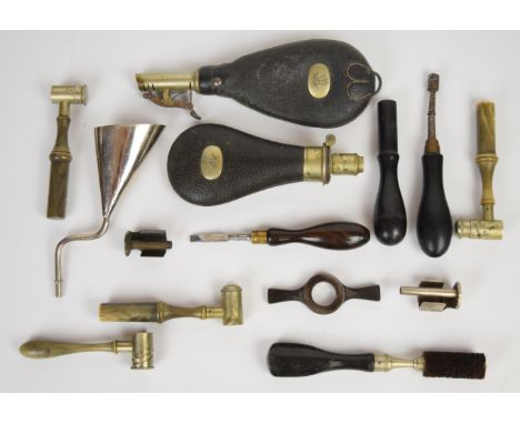 A collection of gun tools and accessories including four horn handled powder measures and four cleaning and servicing tools m