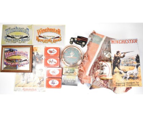 A collection of Winchester signs and ephemera comprising three mirrors, two metal signs, four tins, a clock, stein, three mod