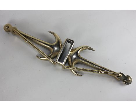 A ship's brass pulley item with two conjoined anchors and terminals with pulleys, 52cm