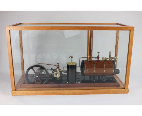 A Maxwell Hemmens table top marine steam engine, with wood clad boiler, chimney, flywheel, manometer etc, in glass case, case