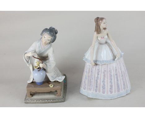 A Lladro porcelain figure of a young woman in a ball gown, together with a Lladro figure of a kneeling Geisha attending to a 