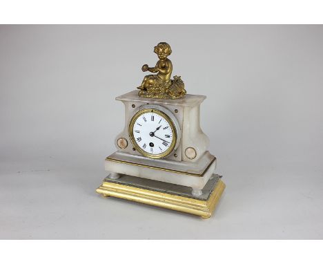 A French gilt metal and onyx mantel clock with 3 inch dial, putti surmount, on rectangular base and giltwood stand (a/f)