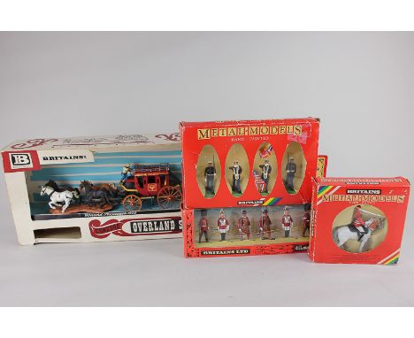 A boxed Britains Overland Stagecoach, together with three boxed Britains metal models comprising four US Marine Corps, six Gu