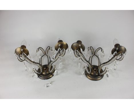 A modern chandelier light fitting with a pair of similar two branch candelabra wall lights both with glass droplets (must be 