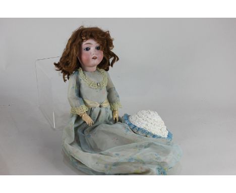 A Max Handwerck bisque head doll, with brown wig, sleeping blue eyes and open mouth, marked Germany Max Handwerck 0 1/4, on j