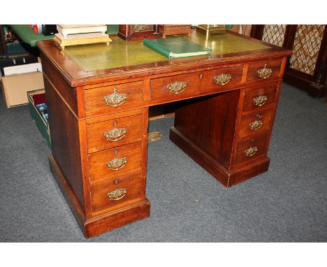 A Victorian pedestal desk, rectangular top with green leather inset, nine drawers, on plinth bases, 107cm