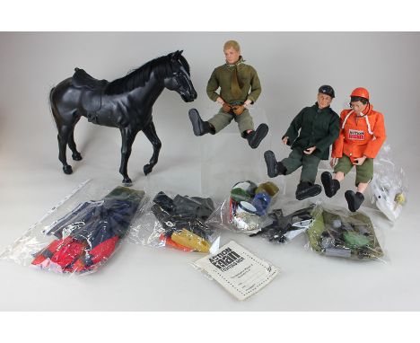 Three Action Man toy figures, a Palitoy Action Man Intelligence Manual, and a collection of outfits, hats, shoes, and other a