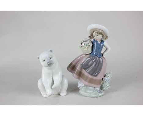 A Lladro porcelain model of a polar bear, and a Lladro figure of a girl holding a basket of flowers