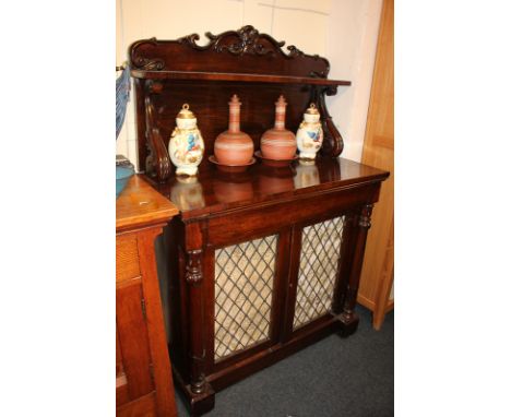 A Victorian rosewood chiffonnier with scrolling foliate raised back and single shelf above drawer and two grille doors, flank