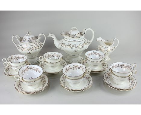 A Victorian porcelain tea set for twelve, Rockingham style form with scrolling gilt design