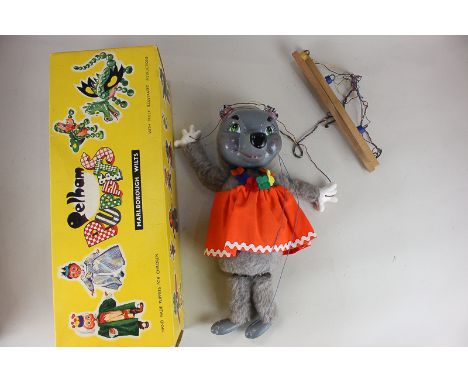 A Pelham puppet of a mother bear in orange skirt with flower garland, boxed