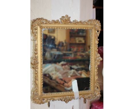 A giltwood and gesso rectangular dressing table mirror with scroll decorated border, on easel stand (a/f), 36cm