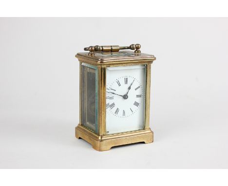 A brass and bevelled glass cased miniature carriage clock with Roman numerals, marked France, with a case 9cm high, (a/f)