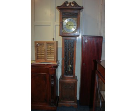 A reproduction oak longcase clock, the movement stamped 'Original Kieninger Made in Germany' with Westminster chime and three