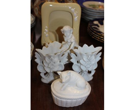 A pair of white glazed porcelain vases, 10cm, another with a child figure, an oval pot, the lid with seated pig, 9.5cm, and a