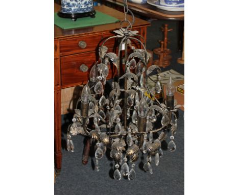 A modern chandelier light fitting with bronzed metal leaf design and glass droplets (must be tested by an electrician before 