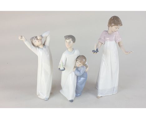 A Nao porcelain figure of a girl with a candle, together with two Lladro figures of boys in nightshirts, one with a candle, t