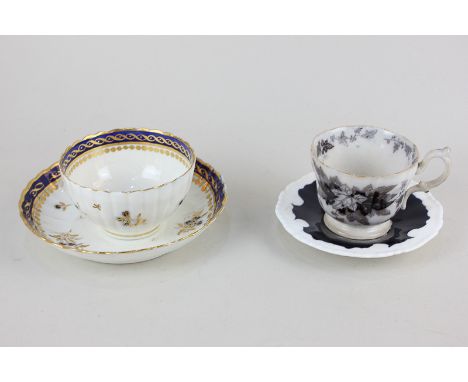 An 18th century porcelain tea bowl and saucer with blue and gilt floral decoration and scalloped rim, possibly Caughley / Wor