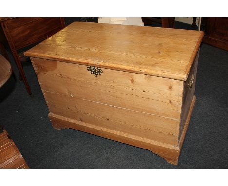 A pine trunk with brass carry handles, on plinth base, 95cm