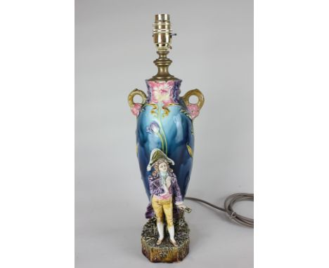 An Art Nouveau majolica table lamp base mounted with a figure wearing an admiral's hat, 40cm high