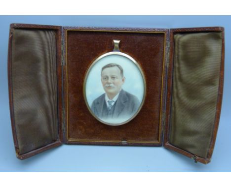 A miniature oval portrait, in gold plated frame and set in a mount with back stand in a fitted case 