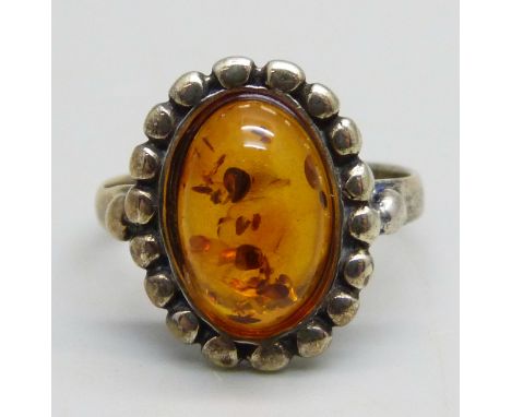 A silver gilt ring set with cabochon Baltic amber, M 