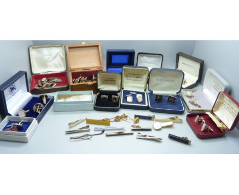 A large bag of cufflinks and tie pins 