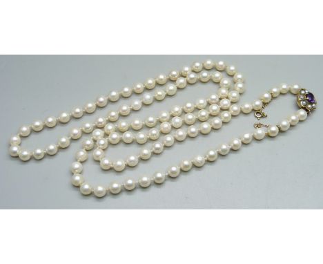 A long pearl necklace with 9ct gold clasp set with an amethyst and pearls, 83cm, 47g 